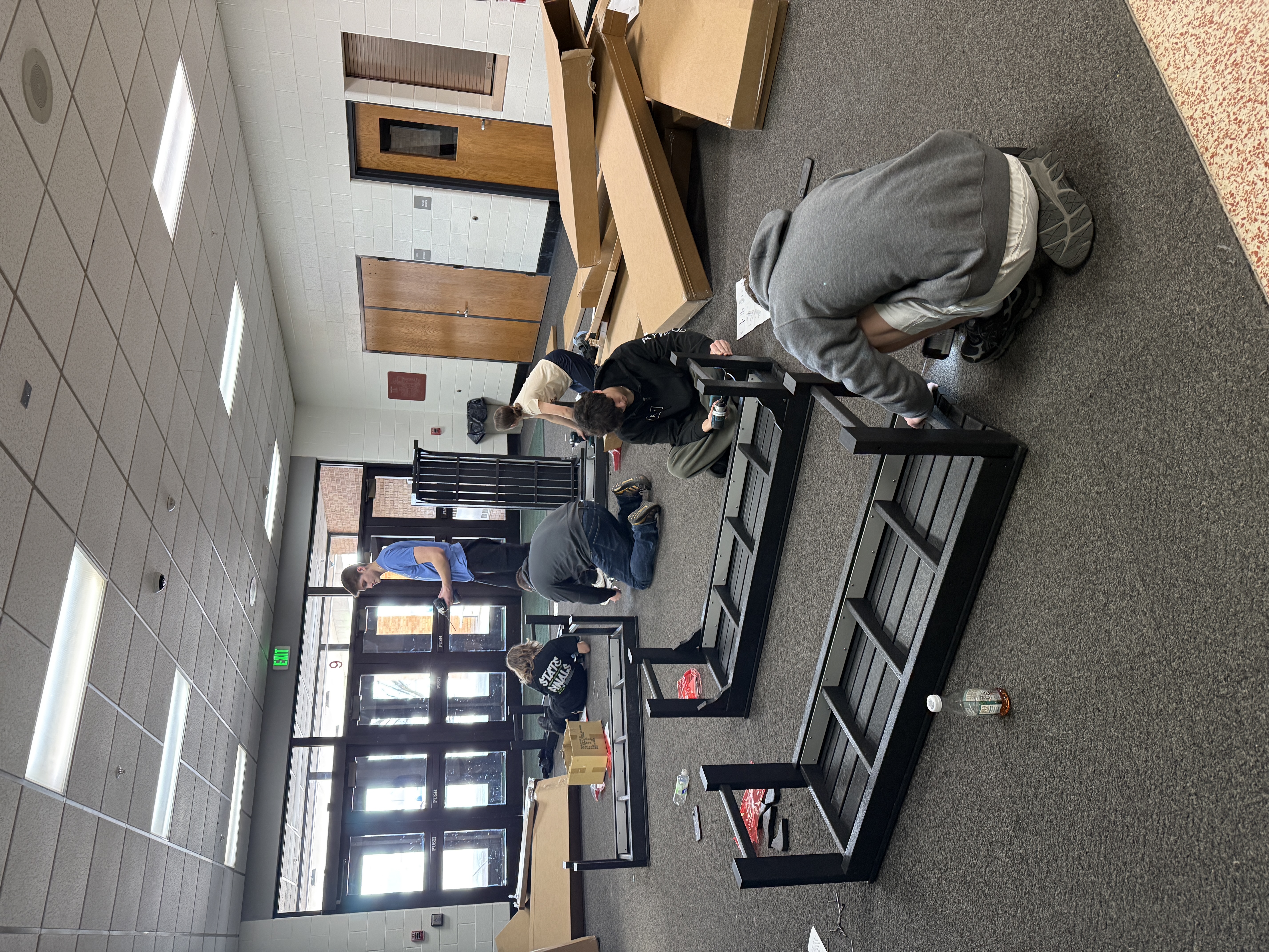 POLYWOOD Academy students work through the bench assembly alongside assembled benches
